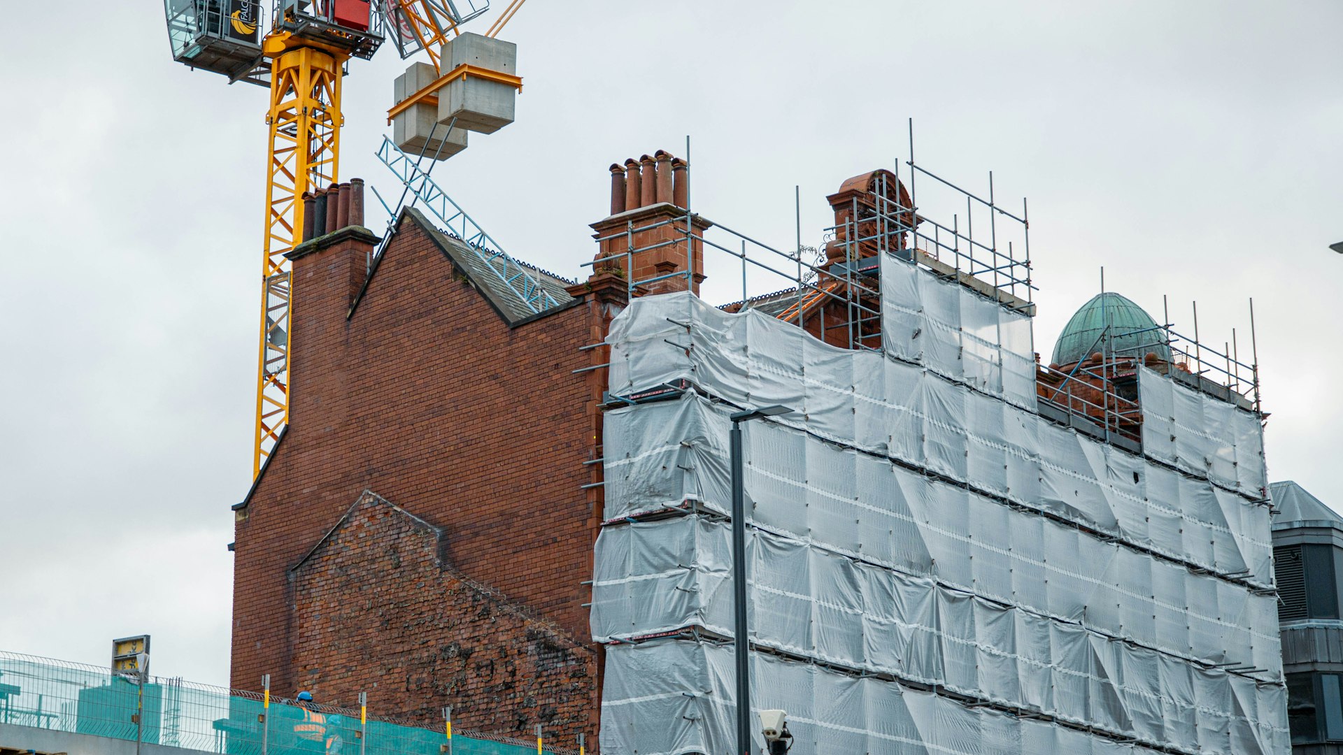 Professional scaffolding with safety features on UK public building